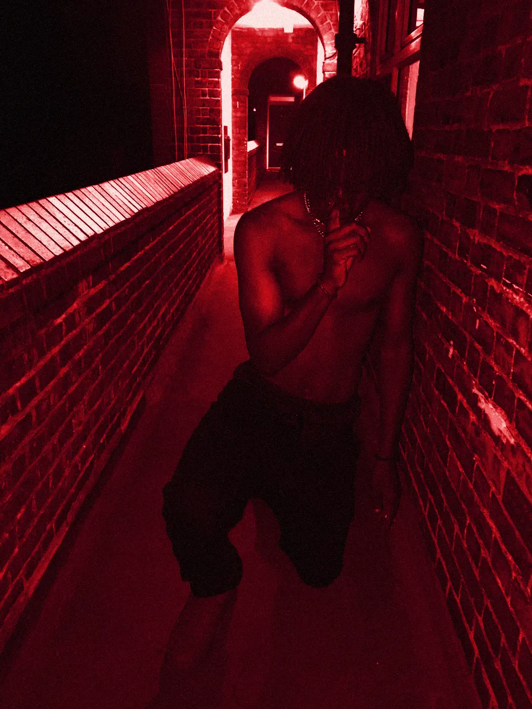 yukan crouched in a narrow brick alley, hand over his mouth.