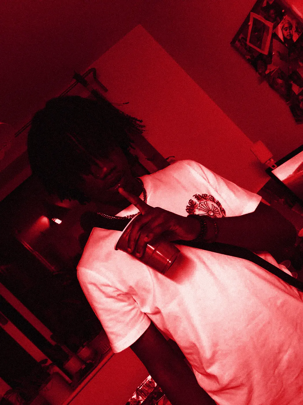 yukan at a house party, red cup in hand, leaning into the frame.